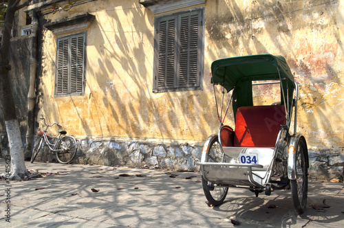 Hoi An Vietnam old Cyclo in front of an ancient house photo