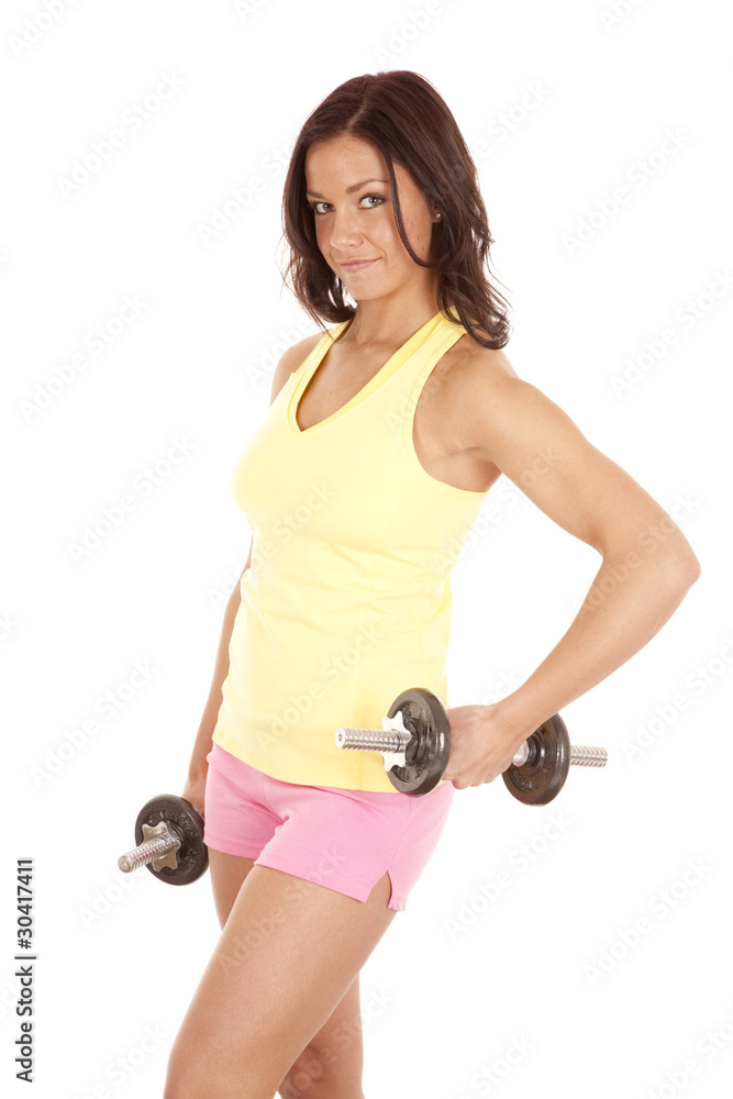 Woman yellow tank top hold weights out Woman yellow tank top hold weights out