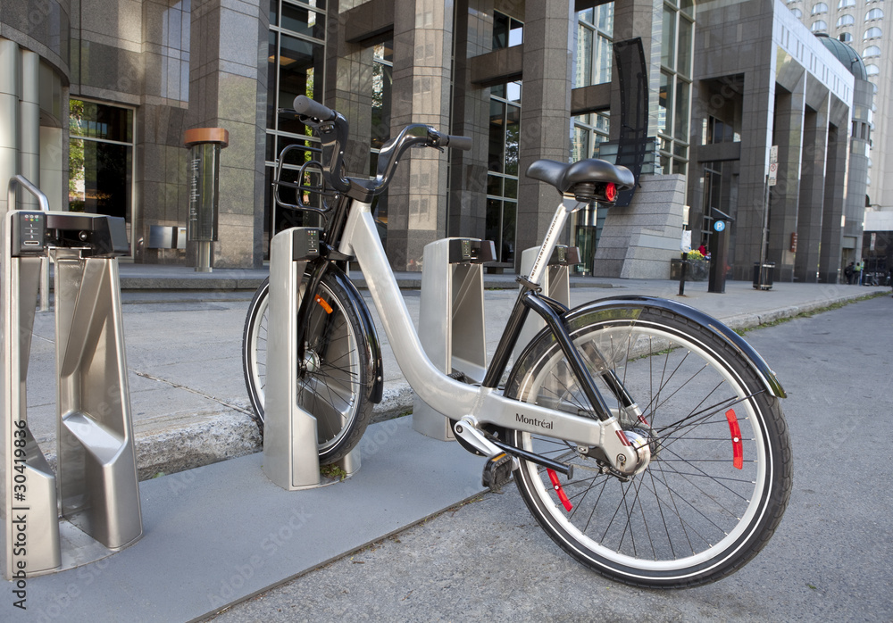 Naklejka premium Bixi public bicycle docking station in front of office building