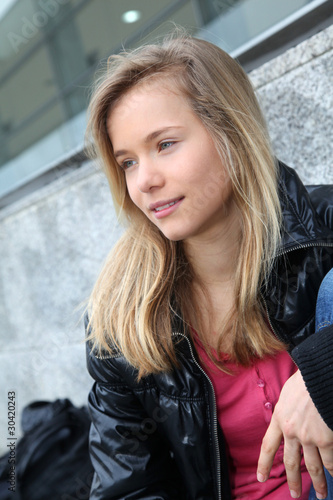 Closeup of teenage girl sitting on a school bench