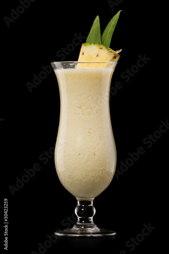 Pina colada drink cocktail glass isolated on black background