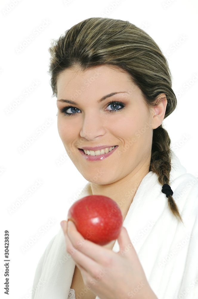 Young beautiful woman in bathrobe eating an apple Young beautiful woman in bathrobe eating an apple