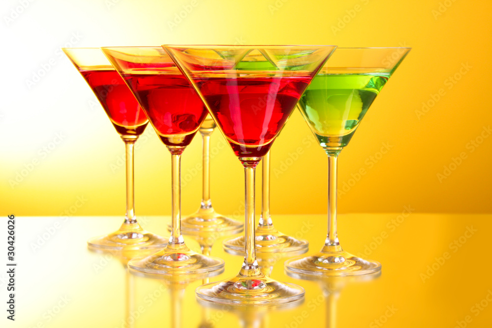 a few glasses of alcoholic drinks in a yellow-brown background