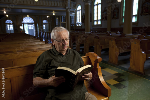 Senior man reading a bible in church