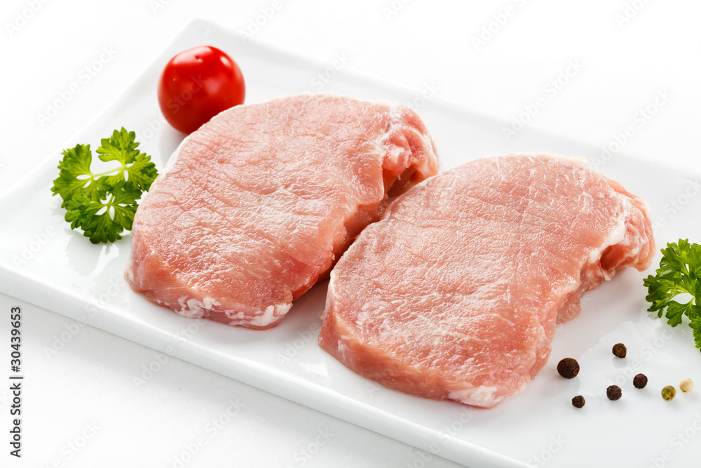 Fresh raw pork on white plate