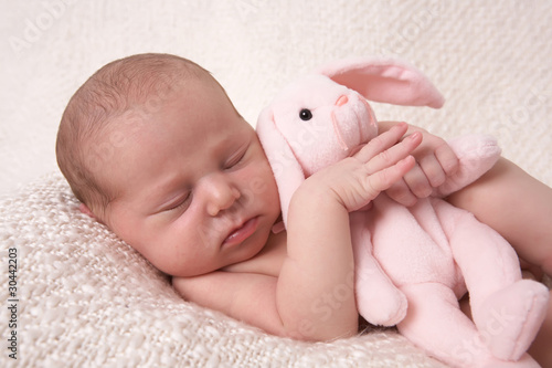 sleeping baby with  pink bunny