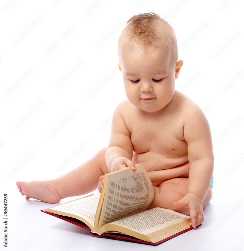 Little child play with book and magnifier Little child play with book and magnifier