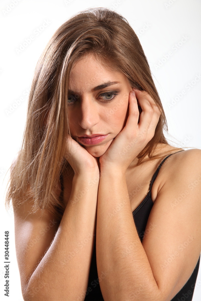 Not interested says young woman with hands over ears Not interested says young woman with hands over ears