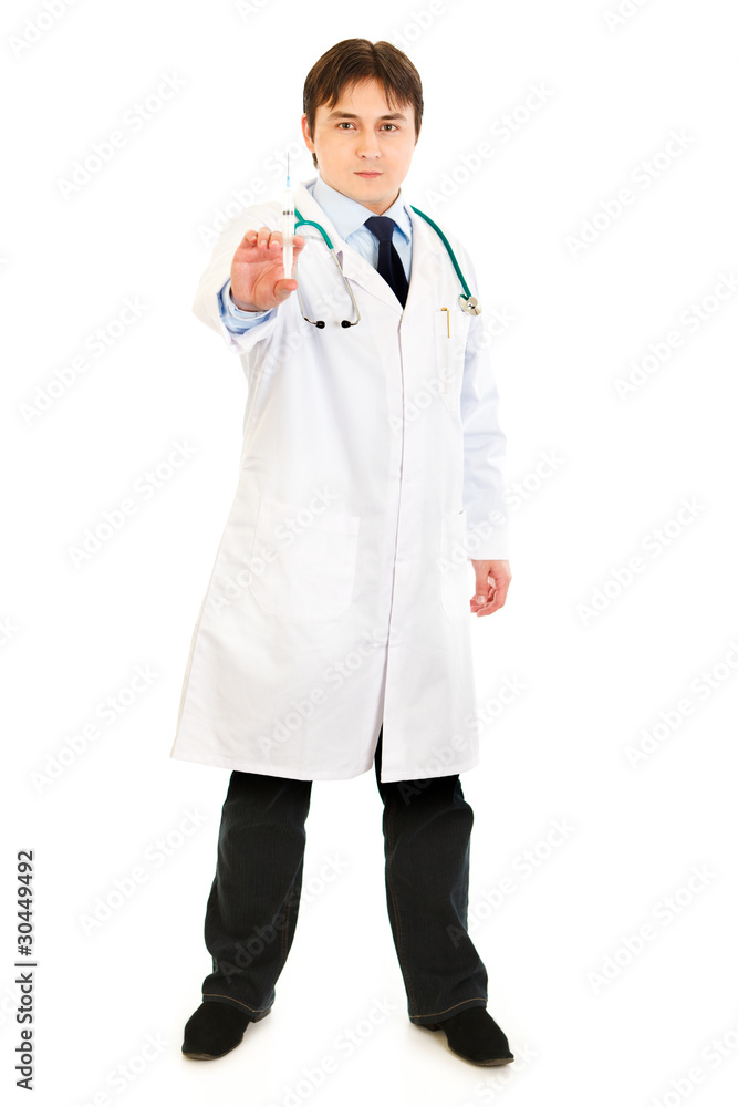 Concentrated medical doctor holding medical syringe in hand Concentrated medical doctor holding medical syringe in hand