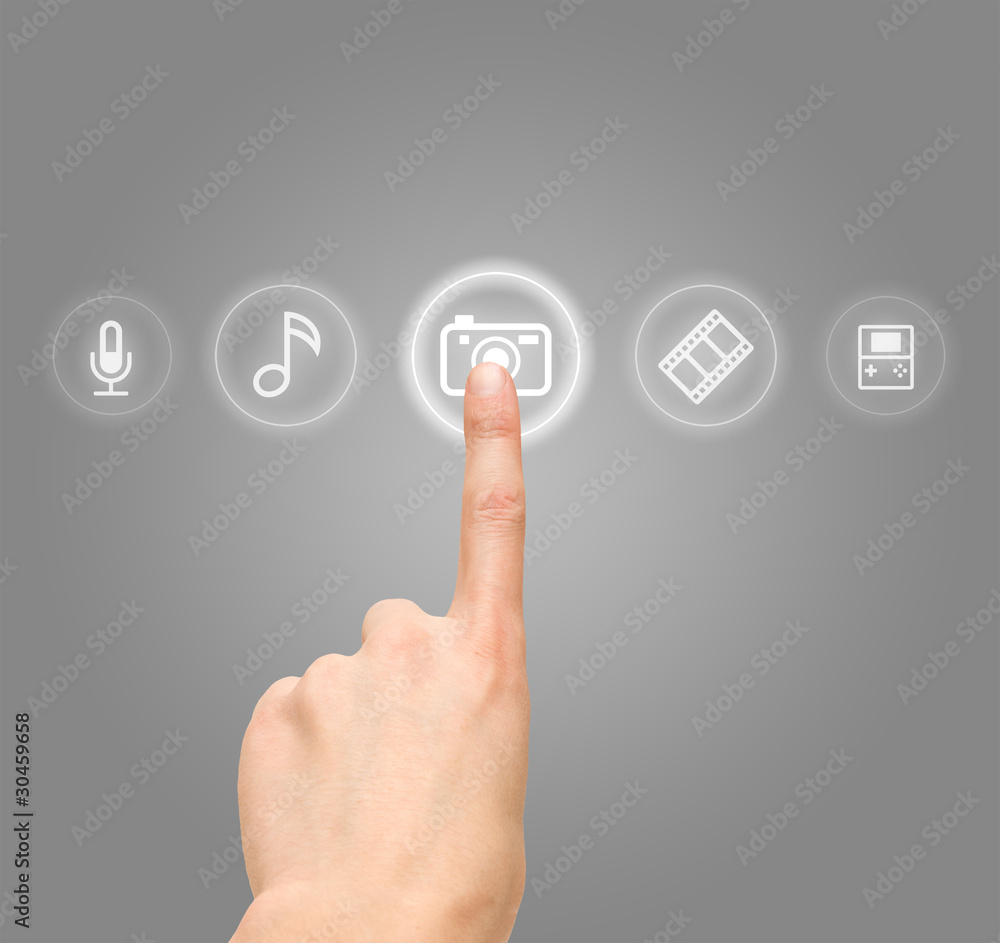 Hand choosing photo camera symbol from media icons Hand choosing photo camera symbol from media icons