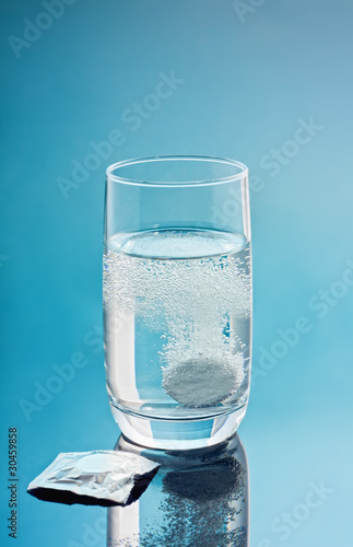 Painkiller tablet in glass