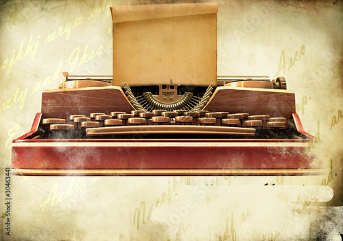 Old typewriter with a sheet of paper on retro background