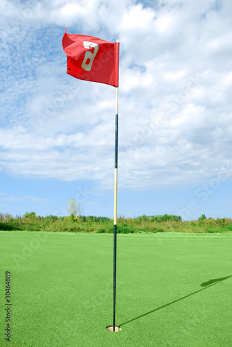 golf field with red flag photo