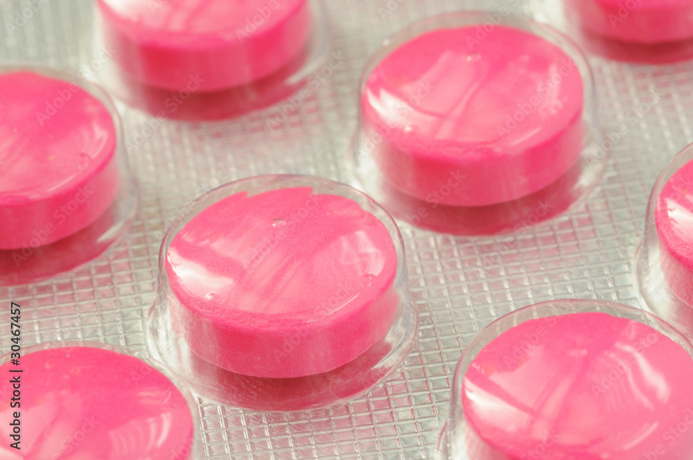 Detail shot of a pink pill Detail shot of a pink pill
