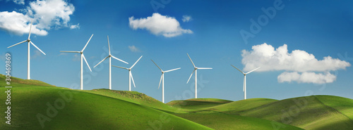 Wind turbines on green hills photo