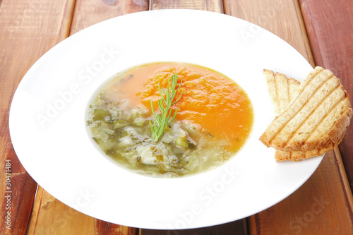 dual components vegetable soup served with toasts