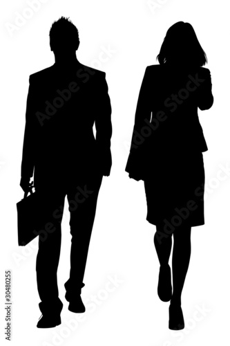 Two businesspersons in formal clothes are going somewhere