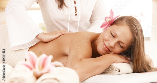 Smiling woman enjoying back massage