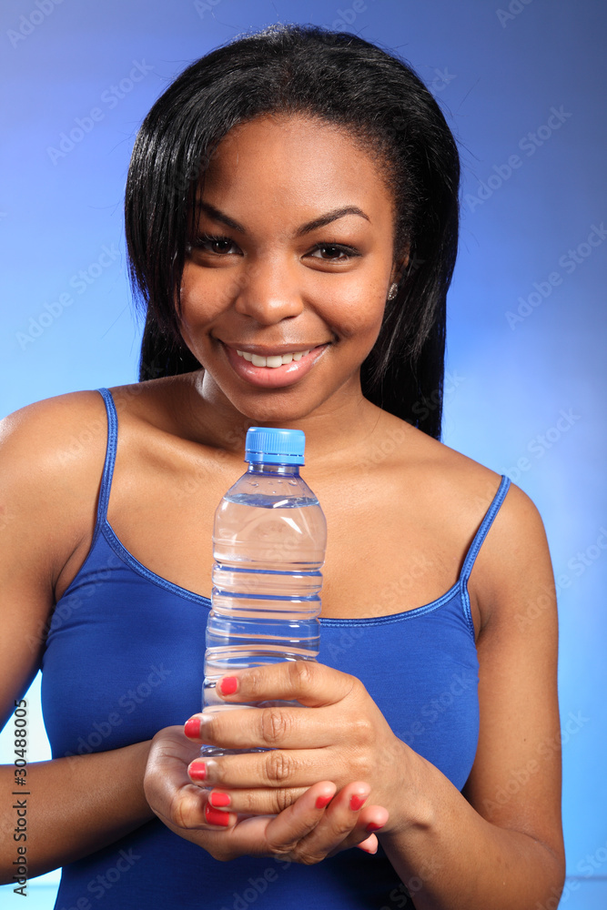 Beautiful smiling black woman with bottled water Beautiful smiling black woman with bottled water