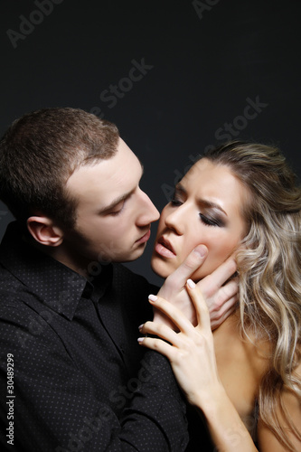 handsome man is about to kiss a beautiful woman