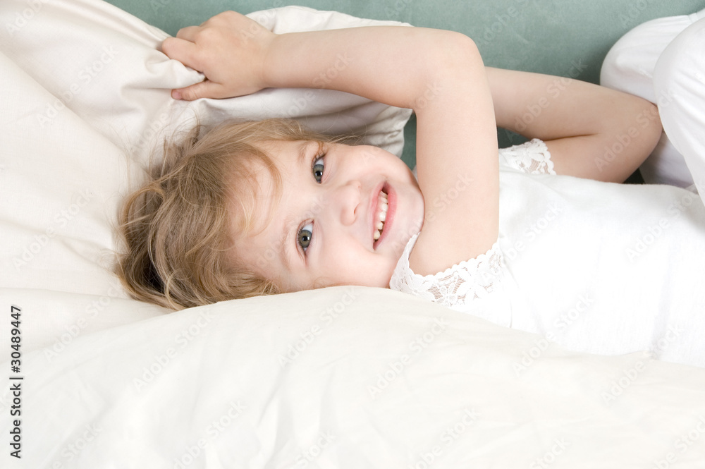 Adorable little girl resting in the bed Adorable little girl resting in the bed