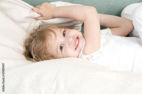 Adorable little girl resting in the bed