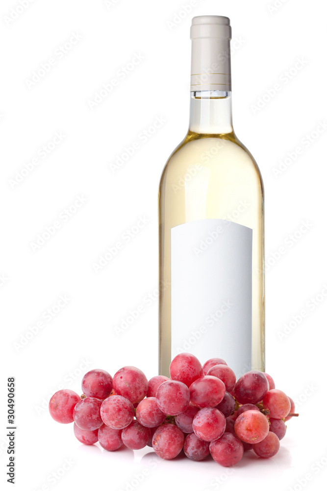 White wine in bottle and red grapes