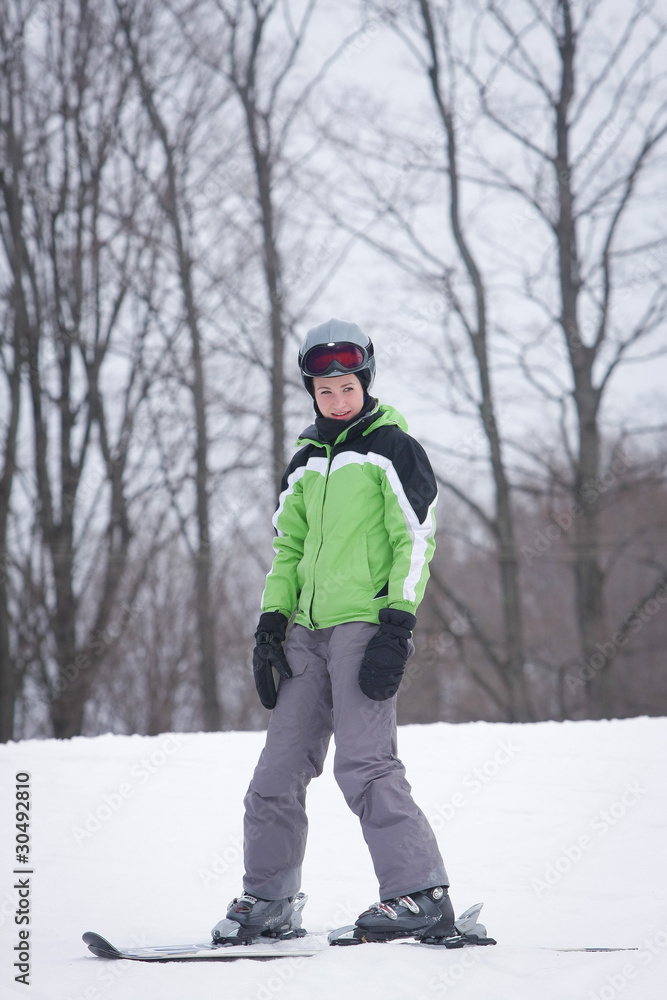 Teen Skier against background of snow and woods.