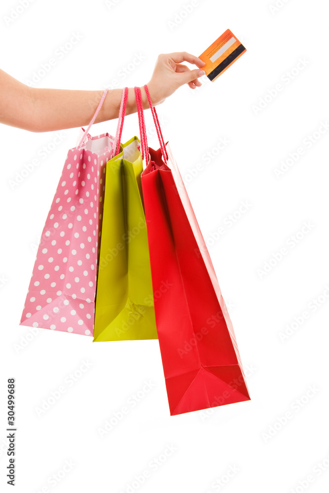 Female hand holding shopping bags and credit card