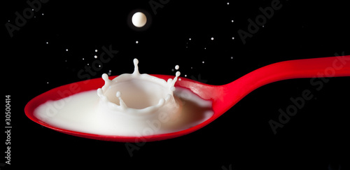 Milk splashing into spoon