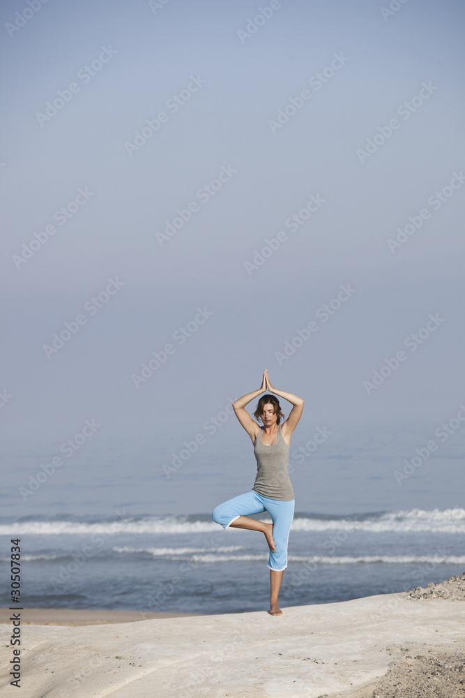 Beautiful young woman with arms open, relaxing on the beach Beautiful young woman with arms open, relaxing on the beach