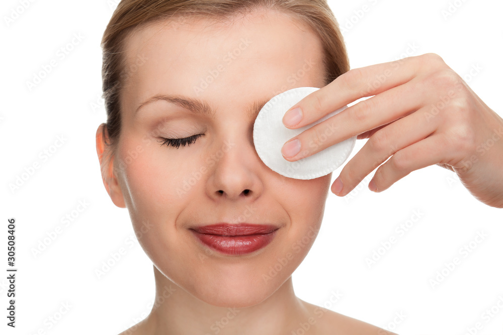 woman using a makeup remover pad woman using a makeup remover pad