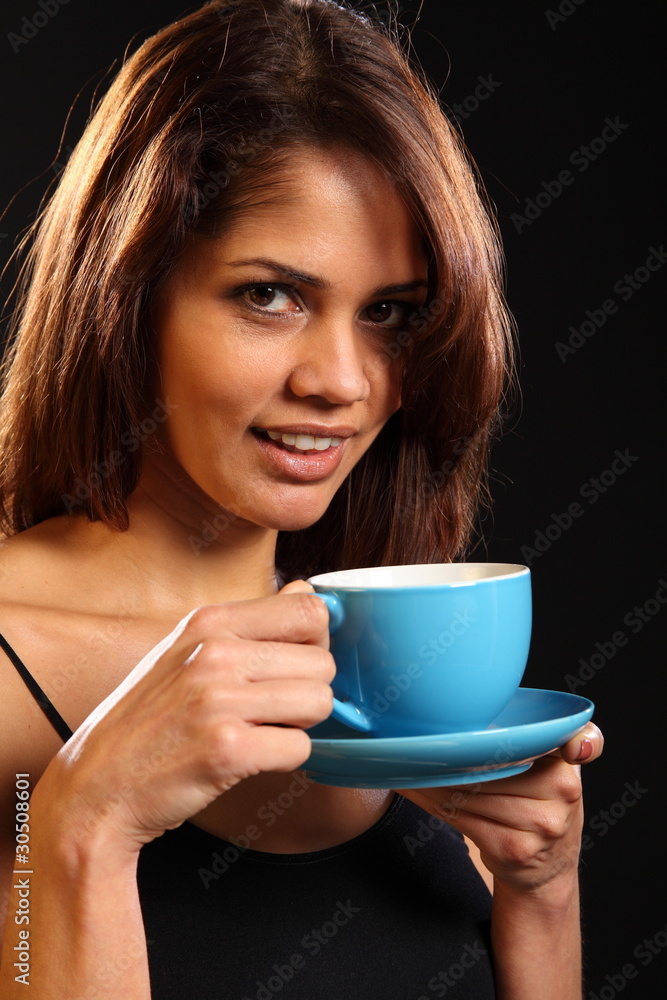 Young woman with a refreshing cup of tea on black background Young woman with a refreshing cup of tea on black background