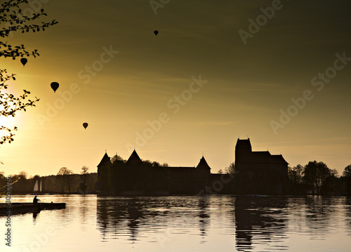 Hot air ballon over the lake in night.