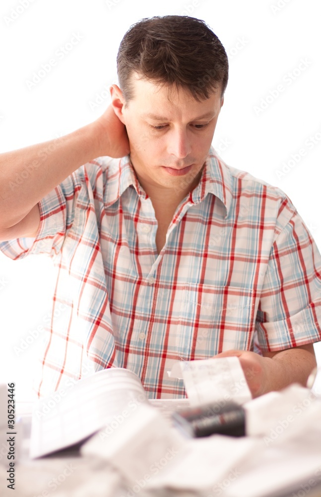Man holding receipt while making tax computation Man holding receipt while making tax computation