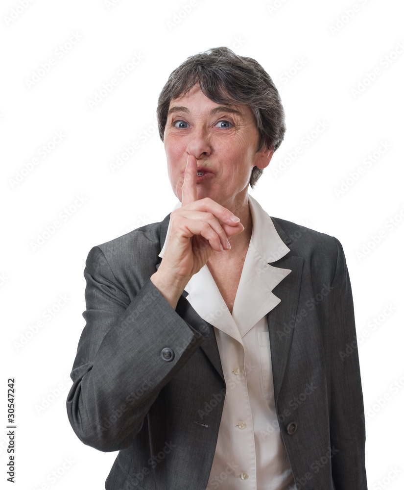 Happy mature woman saying shh with her forefinger Happy mature woman saying shh with her forefinger