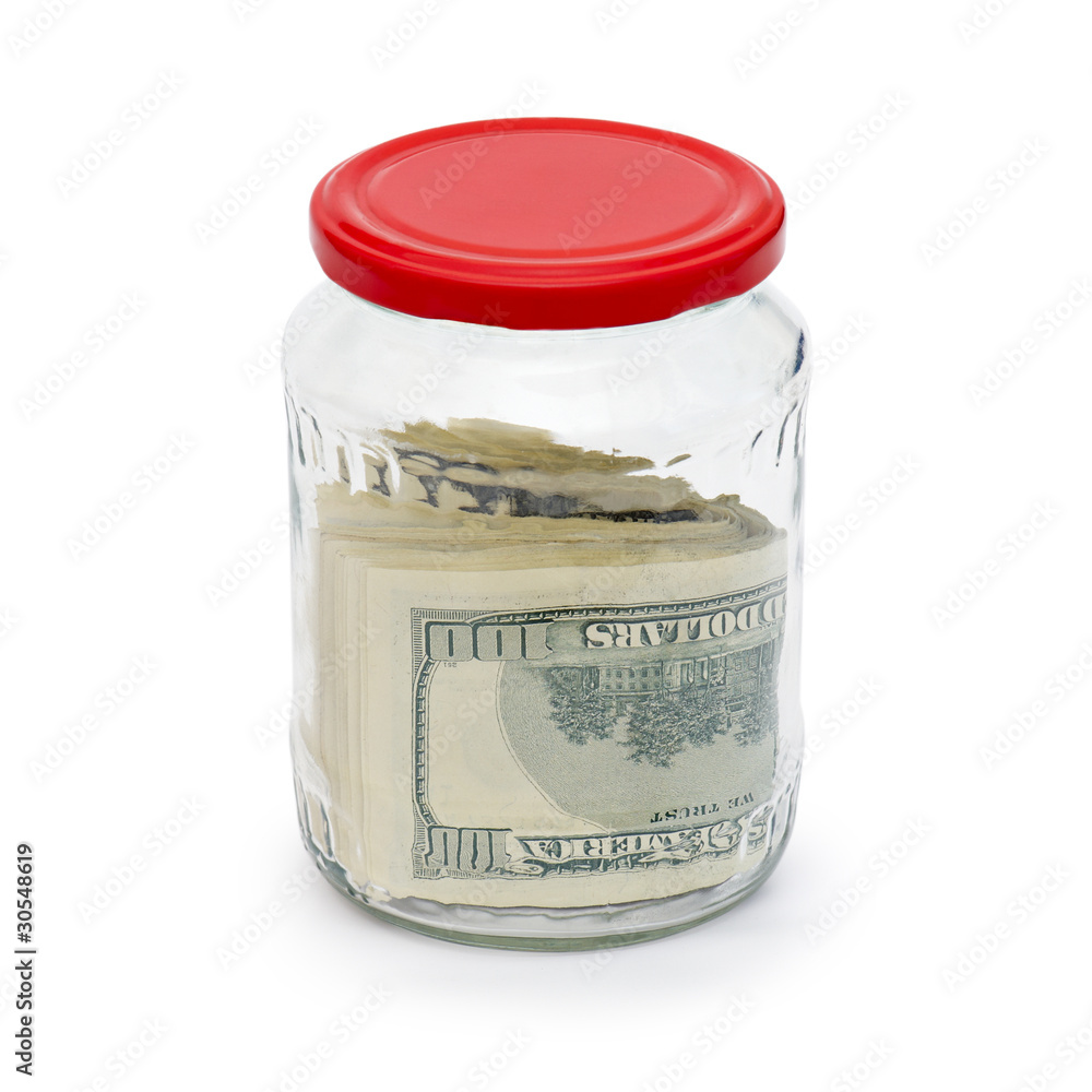 Money in a glass jar is isolated Money in a glass jar is isolated