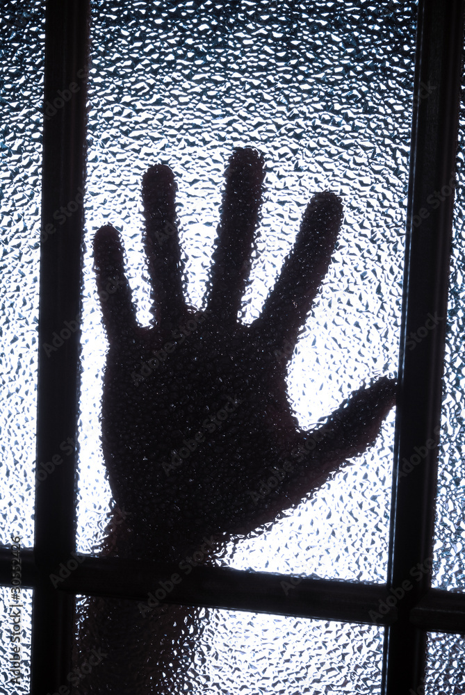 Hand behind glass