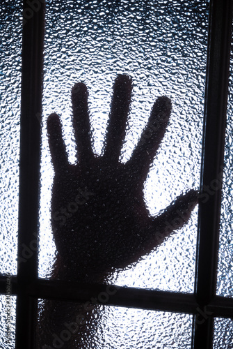 Hand behind glass