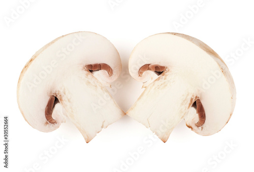 Two sliced champignon mushrooms on white backround