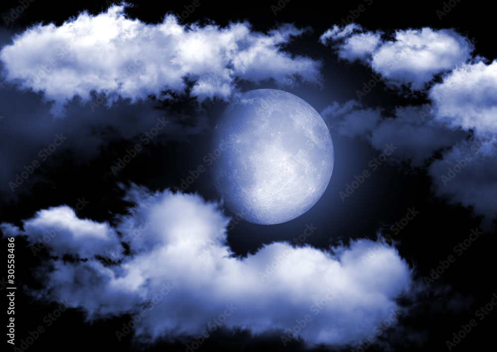 Naklejka premium The moon in the night sky in clouds