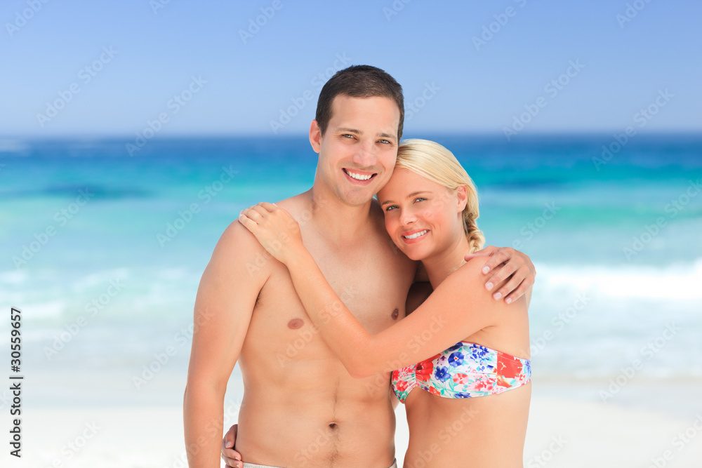 Woman huging her husband on the beach Woman huging her husband on the beach