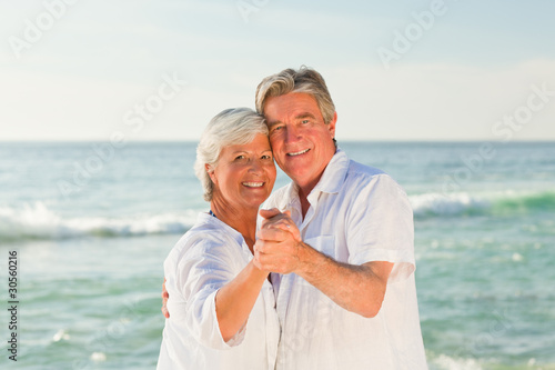 Mature couple dancing on the beach