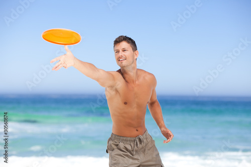 Man playing frisbee photo