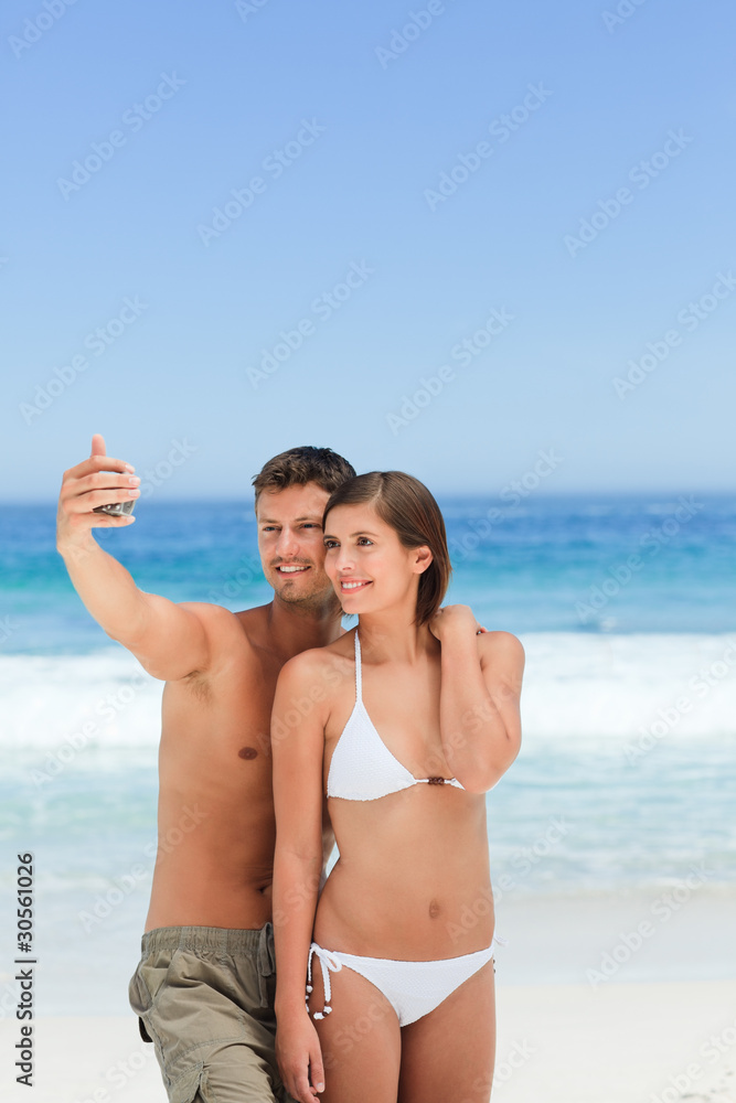 Lovers with their camera at the beach