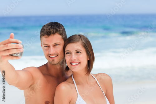 Lovers with their camera at the beach