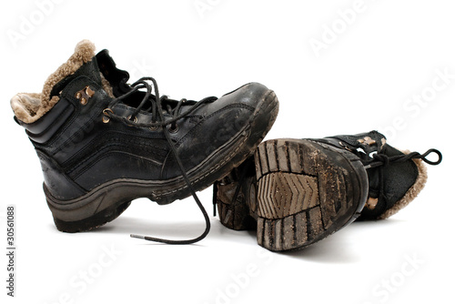 warm old dirty shoes lie on a white background