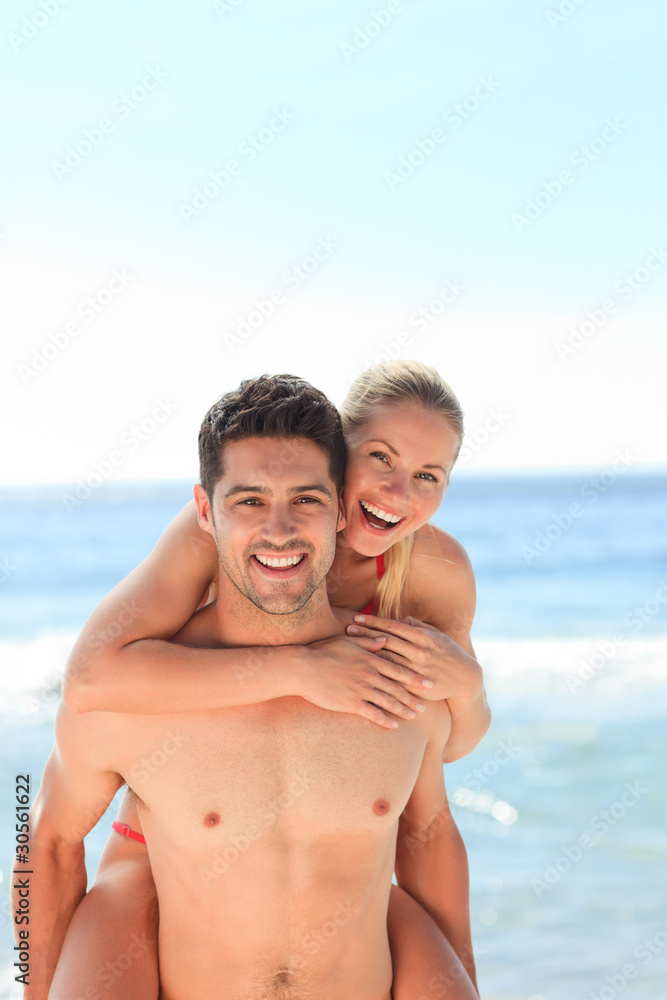 Beautiful man having girlfriend a piggyback Beautiful man having girlfriend a piggyback