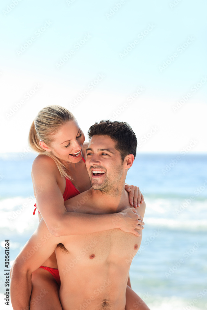 Beautiful man having girlfriend a piggyback Beautiful man having girlfriend a piggyback