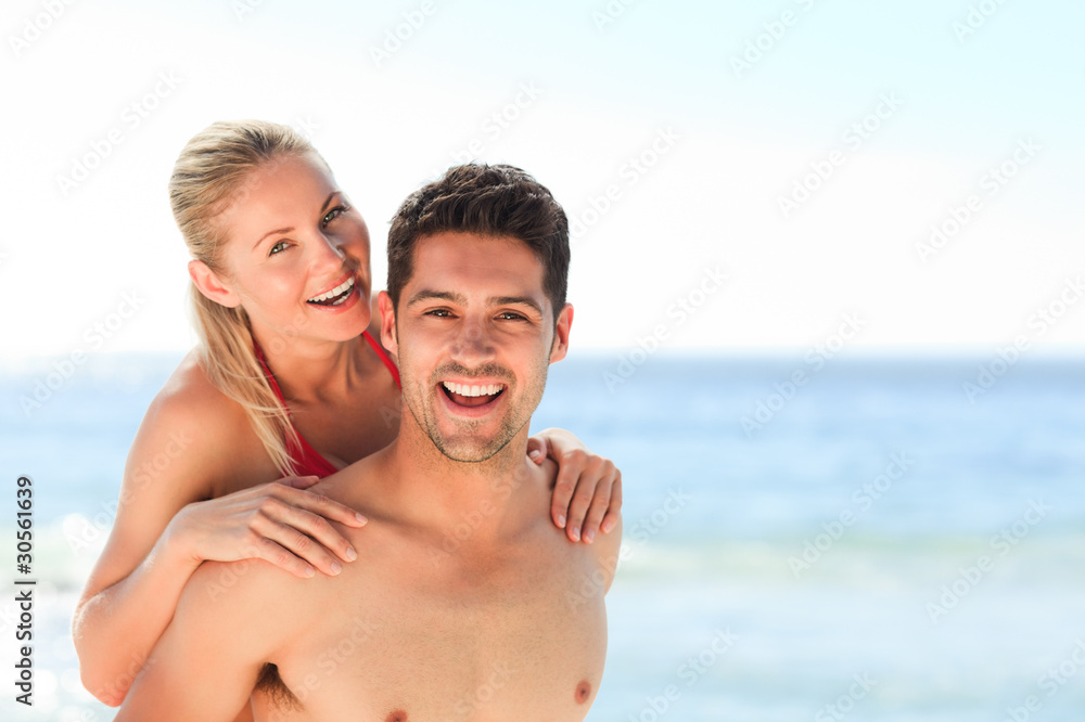 Beautiful man having girlfriend a piggyback Beautiful man having girlfriend a piggyback